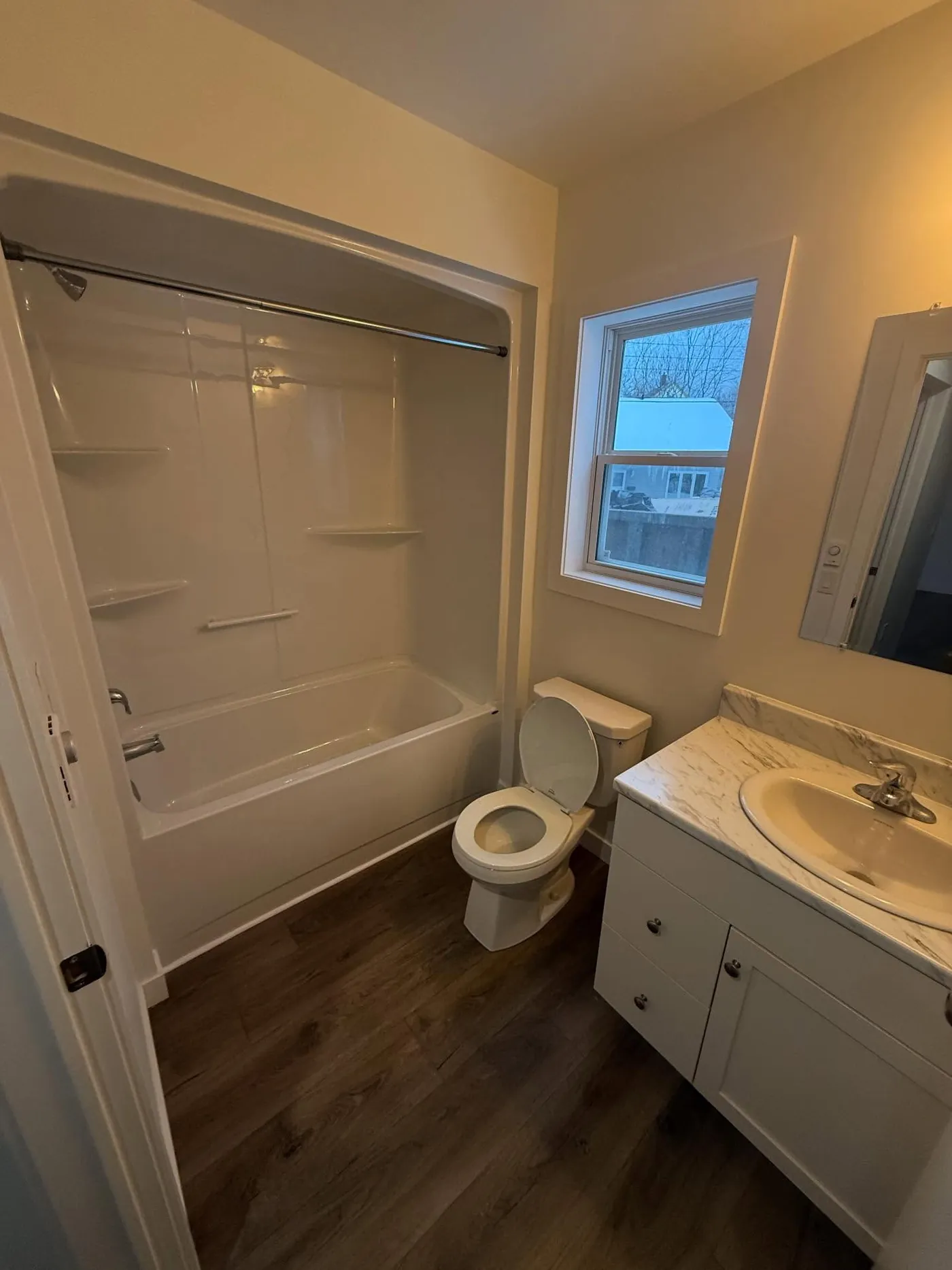 Renovated bathroom with a marble-top vanity in a Halifax home