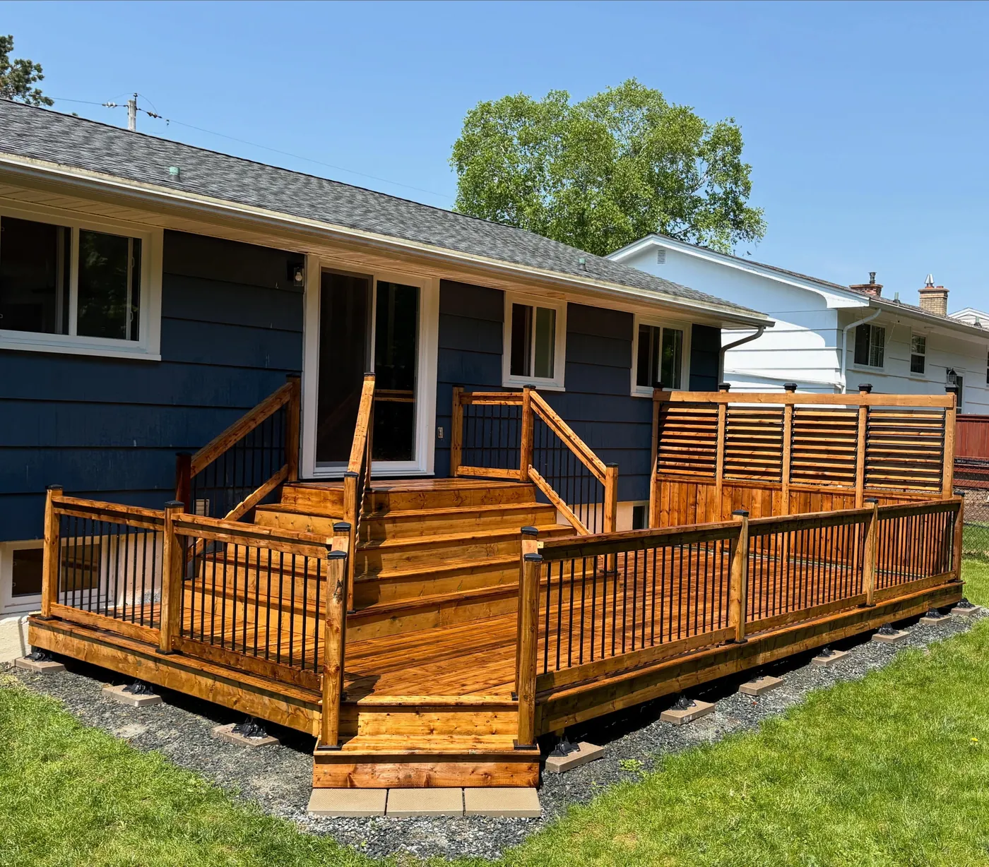 Cedar deck and railing on a navy home in Bedford, Nova Scotia
